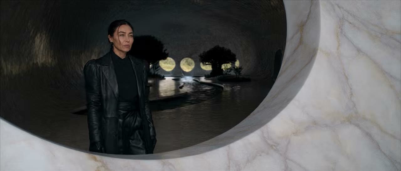 A woman framed by a marble window in Veil of Maya