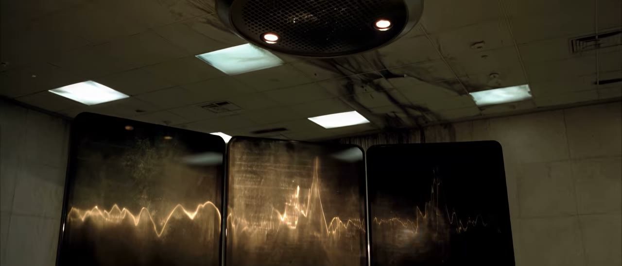 A concrete room of signal screens in Veil of Maya