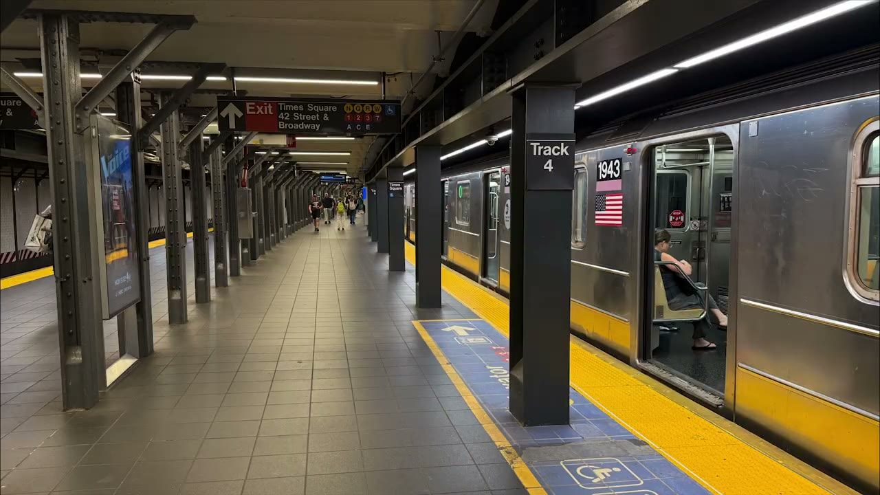 An empty New York subway platform beside a train, photographed